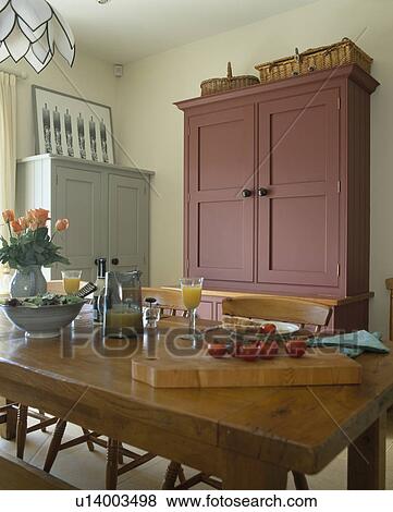 Large Brown Painted Cupboard In Traditional Dining Room With Wooden Table Stock Photo U14003498 Fotosearch