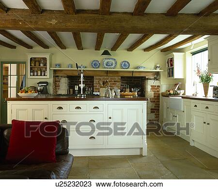 Large cream island unit with storage drawers in beamed country kitchen View Large Photo Image Stock Image - Large cream island unit with storage drawers in beamed country kitchen. Fotosearch