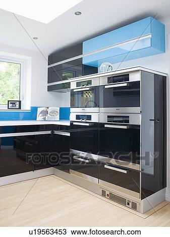Large double ovens in modern blue and black kitchen View Large Photo Image Stock Image - Large double ovens in modern blue and black kitchen. Fotosearch