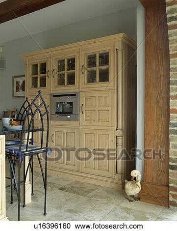 Stock Image - Large fitted cupboard with fitted microwave oven. Fotosearch