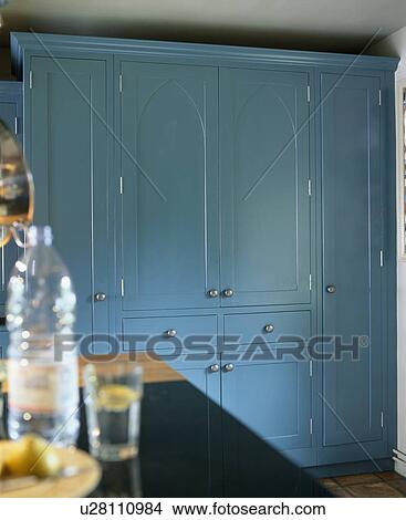 Picture - Large fitted larder cupboard painted in blue Farrow+Ball paint in traditional kitchen. Fotosearch