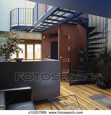 Large modern hall with spiral staircase and black sofa View Large Photo Image Stock Photography - Large modern hall with spiral staircase and black sofa. Fotosearch