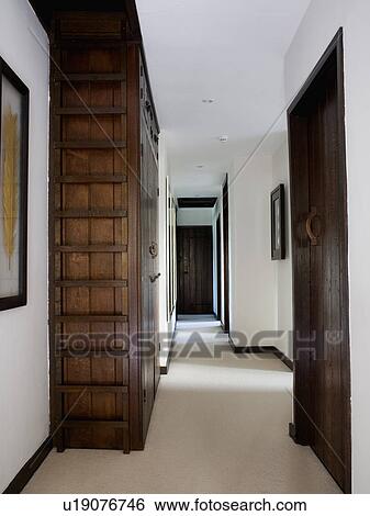 Large oak cupboard on landing with cream flooring View Large Photo Image Stock Photograph - Large oak cupboard on landing with cream flooring. Fotosearch