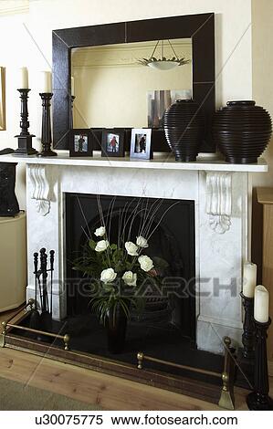 Large rectangular black-framed mirror on marble fireplace View Large Photo Image Stock Photography - Large rectangular black-framed mirror on marble fireplace. Fotosearch