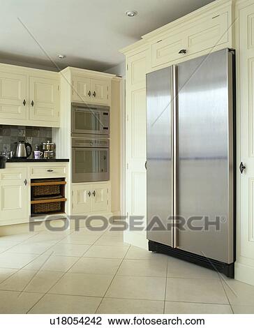 Large stainless steel fridge-freezer in cream kitchen with cream floor tiles View Large Photo Image Stock Image - Large stainless steel fridge-freezer in cream kitchen with cream floor tiles. Fotosearch