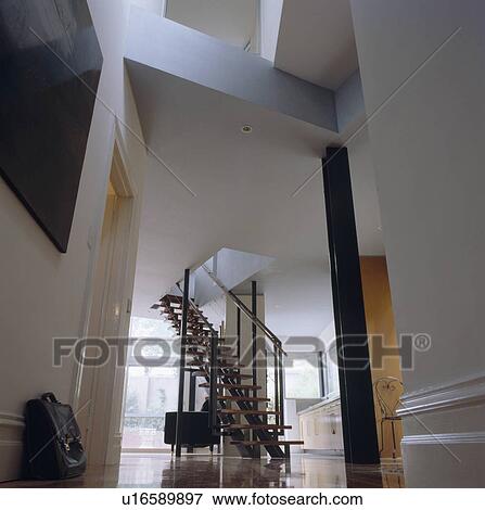Stock Photo - Large white architectural hall with black staircase. Fotosearch