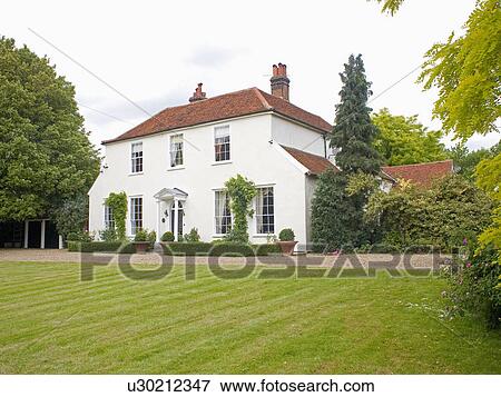 Stock Photo - Large white country house with newly mown lawn. Fotosearch