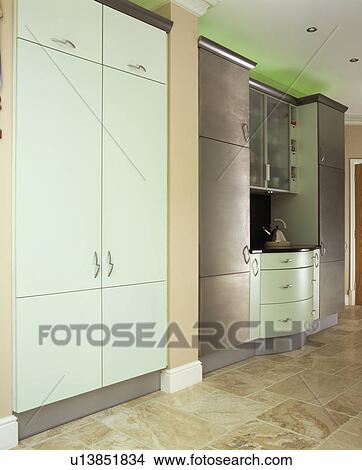 Picture - Large white fitted storage cupboard in modern kitchen. Fotosearch