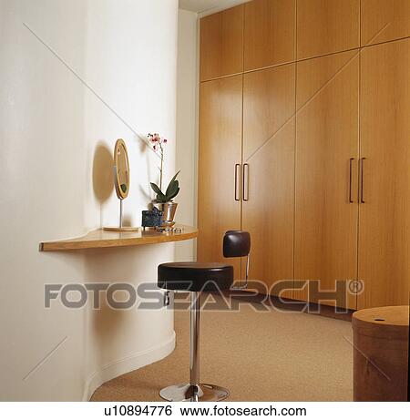 Leather stool at shelf in modern bedroom with fitted wardrobe View Large Photo Image Stock Photograph - Leather stool at shelf in modern bedroom with fitted wardrobe. Fotosearch