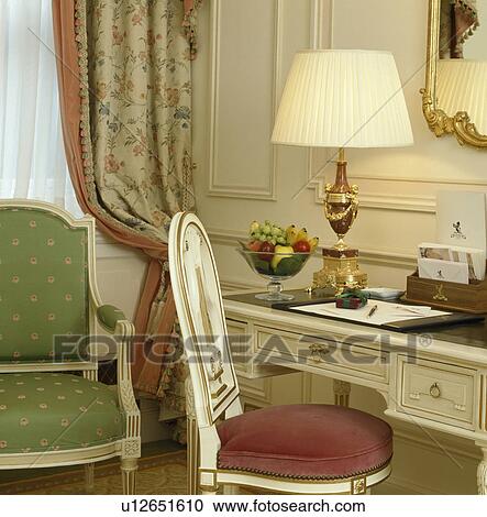 Lighted cream lamp on small desk in townhouse study View Large Photo Image Stock Image - Lighted cream lamp on small desk in townhouse study. Fotosearch