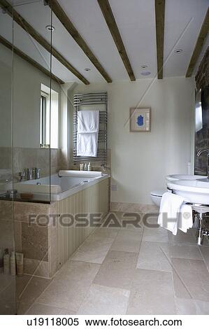 Limestone floor tiles in modern country bathroom with beamed ceiling View Large Photo Image Stock Photography - Limestone floor tiles in modern country bathroom with beamed ceiling. Fotosearch
