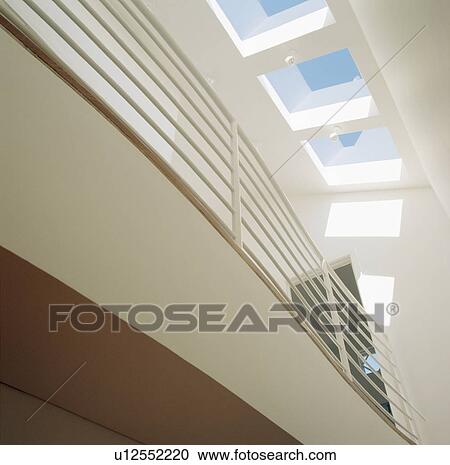 Stock Image - Looking up at metal walkway and glass ceiling. Fotosearch