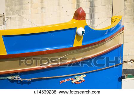 Stock Photo - Luzzu fishing boat in Saint Julian’s Harbour, Spinola Bay, Saint Julian’s, Malta. Fotosearch