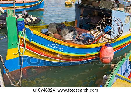 Picture - Luzzu fishing boat moored in Marsaxlokk Harbour, Marsaxlokk, Malta. Fotosearch
