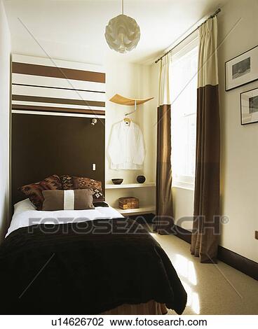 Masculine Modern Bedroom With Brown And Cream Curtains Stock