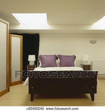 Mauve pillows on sleigh bed in modern loft conversion bedroom View Large Photo Image Stock Photography - Mauve pillows on sleigh bed in modern loft conversion bedroom. Fotosearch