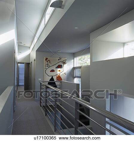 Stock Photography - Metal banister on walkway landing in modern white hall. Fotosearch