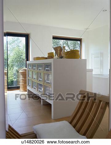 Metal drawers in white storage unit in modern white country kitchen View Large Photo Image Stock Photograph - Metal drawers in white storage unit in modern white country kitchen. Fotosearch