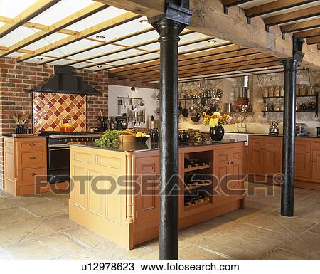 Metal pillar roof supports in country kitchen with large island unit and beamed ceiling View Large Photo Image Stock Image - Metal pillar roof supports in country kitchen with large island unit and beamed ceiling. Fotosearch