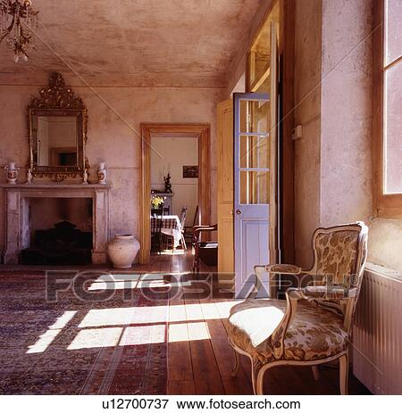 Mirror above fireplace in large country hall with rough stone walls and ceiling View Large Photo Image Stock Photo - Mirror above fireplace in large country hall with rough stone walls and ceiling. Fotosearch