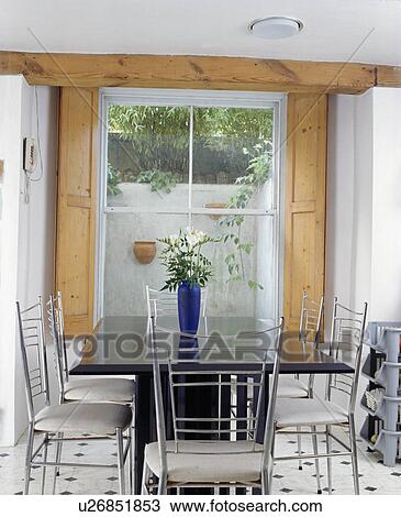 Modern basement dining room with wooden shutters at the window View Large Photo Image Stock Image - Modern basement dining room with wooden shutters at the window. Fotosearch
