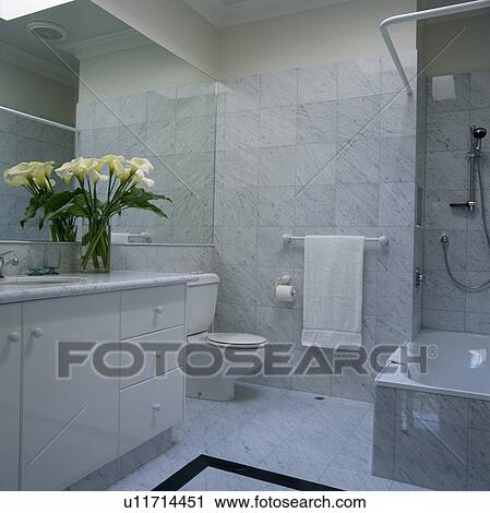 Stock Image - Modern bathroom with grey marble tiled walls. Fotosearch