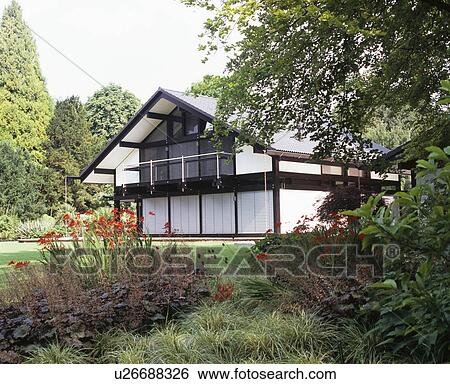Modern black+white chalet-style house in large country garden View Large Photo Image Stock Photograph - Modern black+white chalet-style house in large country garden. Fotosearch