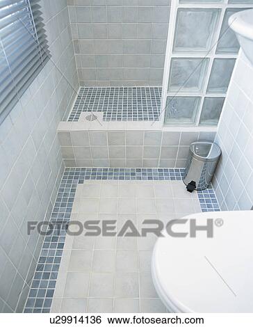 Modern blue tiled bathroom with glass brick shower wall View Large Photo Image Stock Photograph - Modern blue tiled bathroom with glass brick shower wall. Fotosearch