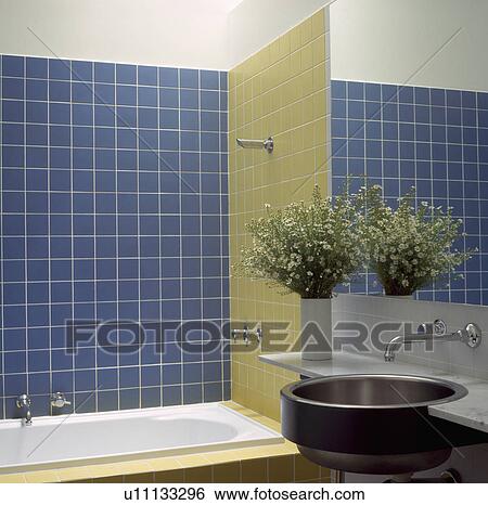 Stock Photograph - Modern blue tiled bathroom with stainless steel circular basin. Fotosearch