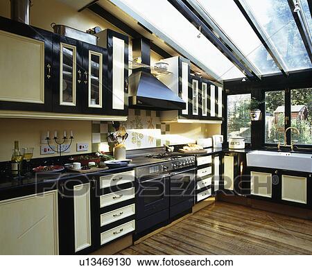 Modern kitchen extension with glass roof and wooden flooring View Large Photo Image Stock Image - Modern kitchen extension with glass roof and wooden flooring. Fotosearch