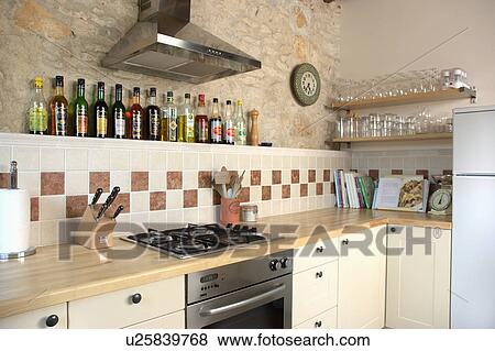 Modern kitchen in stone building with neutral coloured materials and beamed ceiling. View Large Photo Image Stock Photo - Modern kitchen in stone building with neutral coloured materials and beamed ceiling.. Fotosearch