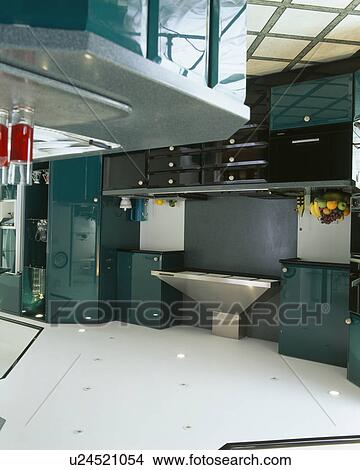Picture - Modern kitchen with dark green fitted units. Fotosearch