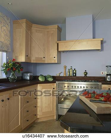 Stock Photo - Modern kitchen with pale wood fitted units. Fotosearch