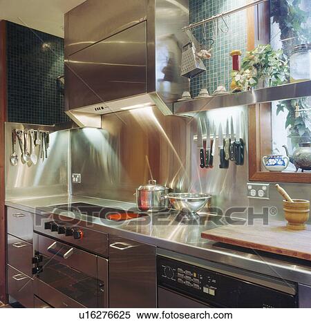 Modern kitchen with stainless steel units and downlighting View Large Photo Image Stock Photography - Modern kitchen with stainless steel units and downlighting. Fotosearch