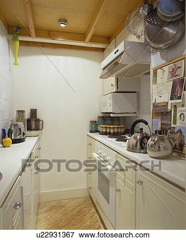 Modern white galley kitchen View Large Photo Image Stock Photo - Modern white galley kitchen. Fotosearch