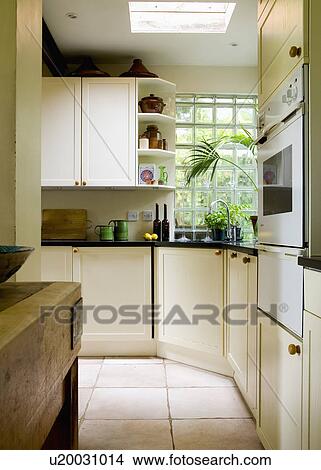Modern white kitchen with limestone floor tiles View Large Photo Image Picture - Modern white kitchen with limestone floor tiles. Fotosearch