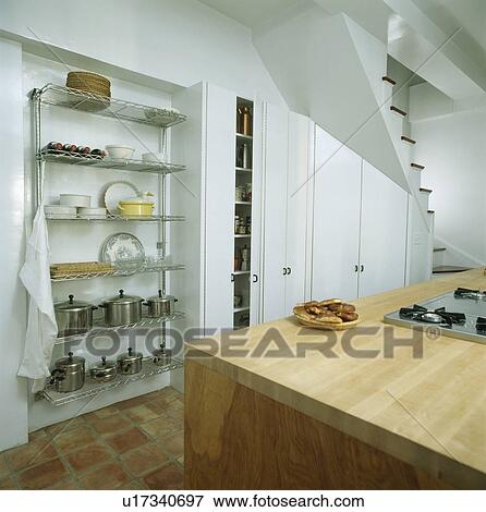 Modern white kitchen with pans on steel alcove shelving View Large Photo Image Stock Photo - Modern white kitchen with pans on steel alcove shelving. Fotosearch