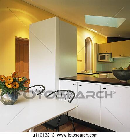Modern white open-plan kitchen and dining room View Large Photo Image Stock Image - Modern white open-plan kitchen and dining room. Fotosearch
