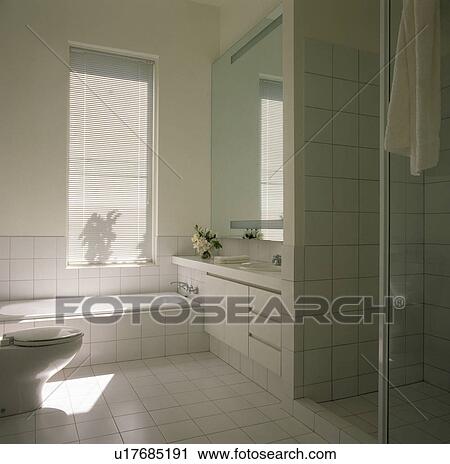 Stock Image - Modern white tiled bathroom. Fotosearch