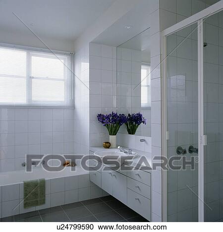 Stock Image - Modern white tiled bathroom. Fotosearch