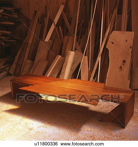 Modern woodern table and planks of wood in carpenter's workshop View Large Photo Image Stock Photograph - Modern woodern table and planks of wood in carpenter's workshop. Fotosearch