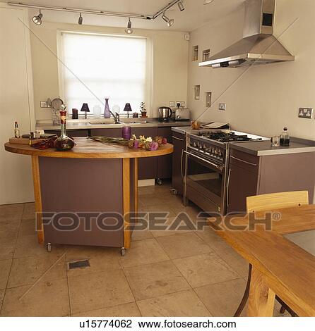 Stock Image - Movable island unit in modern kitchen. Fotosearch