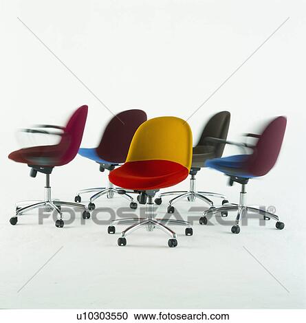 Stock Image - Multicoloured modern office chairs with steel frames and colourful seats. Fotosearch