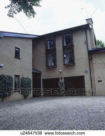 Newbuild brick house with integral double garage View Large Photo Image Stock Photo - Newbuild brick house with integral double garage. Fotosearch