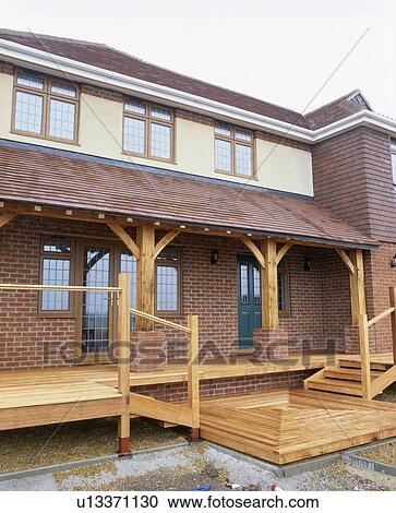 Newly-built brick house with wooden decked veranda View Large Photo Image Stock Image - Newly-built brick house with wooden decked veranda. Fotosearch