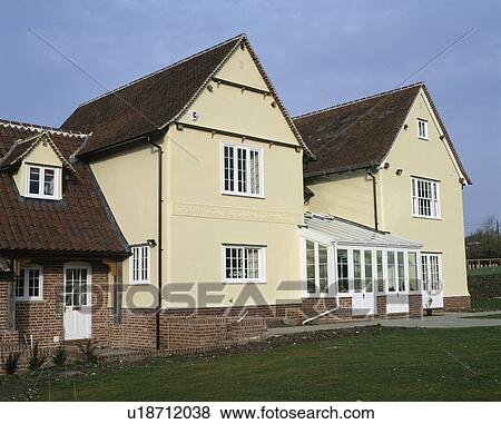 Stock Photo - Newly built traditional house painted in cream. Fotosearch