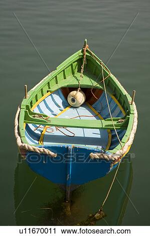 Stock Image - Old green and blue rowing boat in Marsascala on the island of Malta. Fotosearch