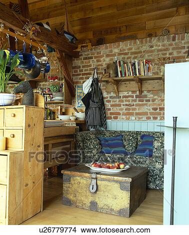 Picture - Old wooden chessgt against brick wall in country kitchen. Fotosearch