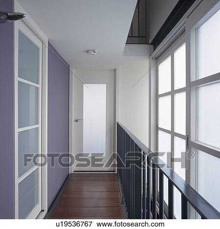 Stock Photo - Opaque glass windows in narrow modern white hall. Fotosearch