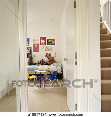 Picture - Open door on landing with view of child's bedroom with colourful chairs and cream carpet. Fotosearch